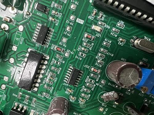 Close-up of an assembled board with SOIC chips, SMD resistors and electrolytic capacitors