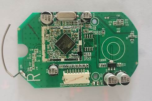 Assembled circuit board with a QFN controller, crystal and electrolytic capacitors, component side